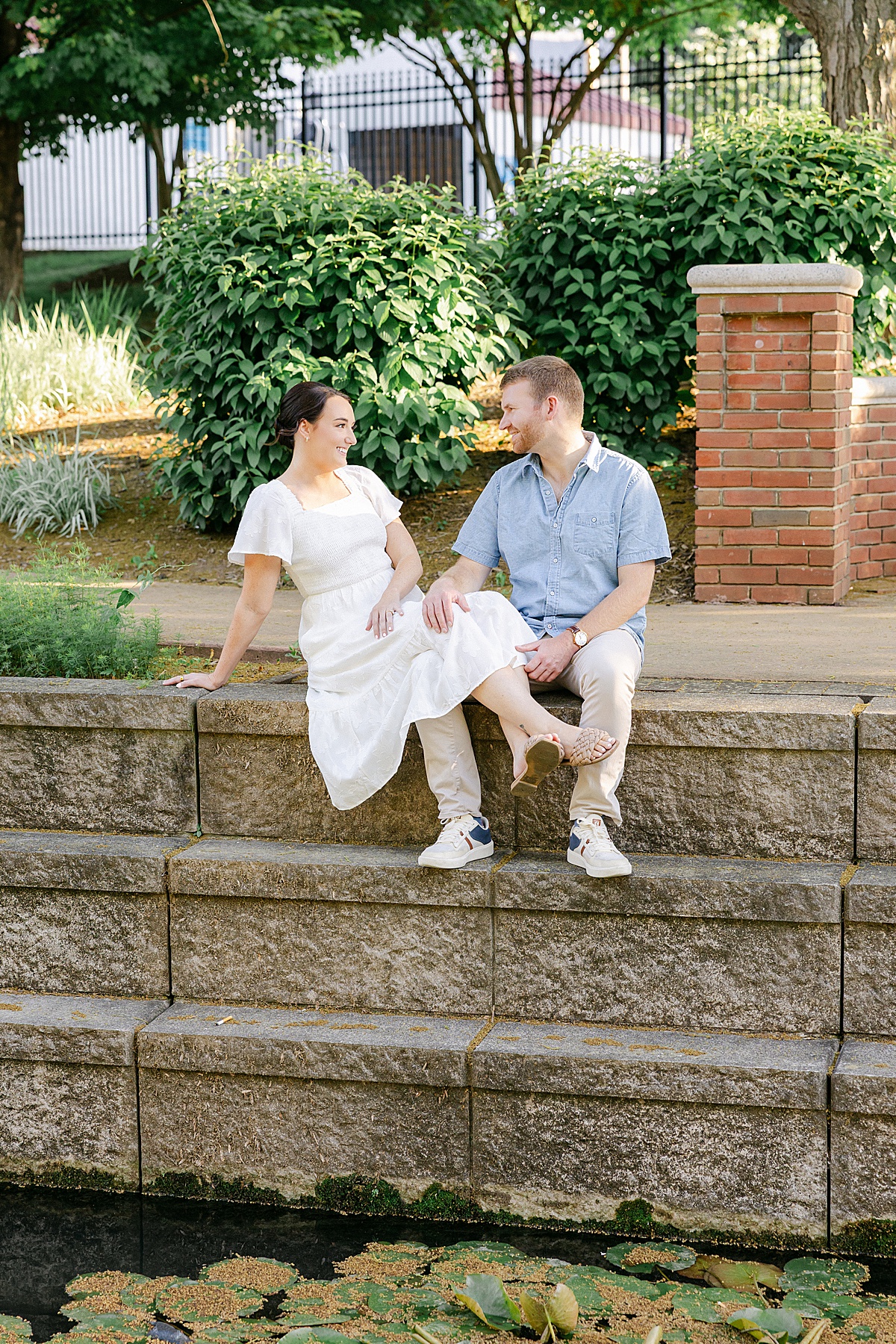 Engaged couple walking Carroll Creek downtown Frederick Maryland — Brittany Thomas Photography