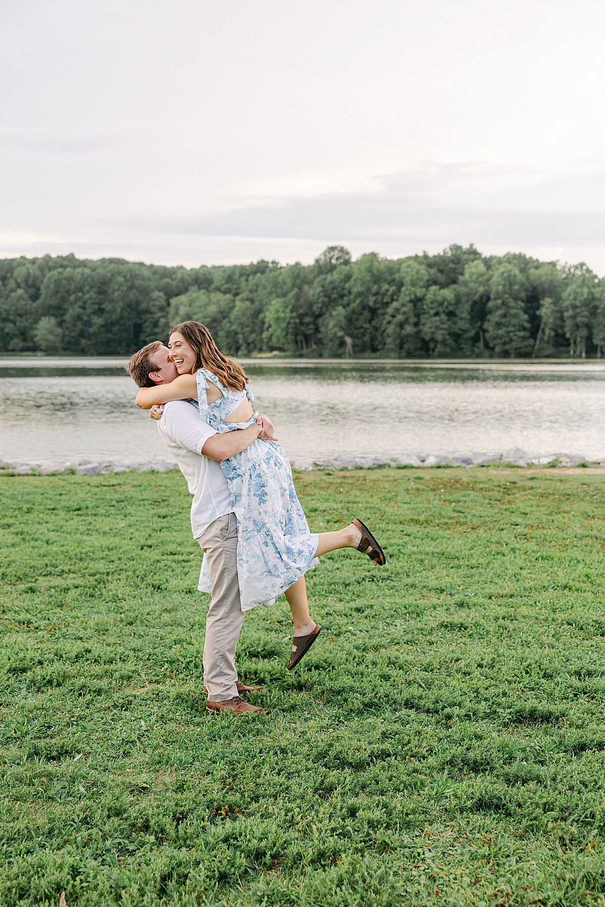 Bride to be in blue and white sundress during sunset engagement session at Centennial Lake Maryland | Brittany Thomas Photography Maryland Wedding Photographer